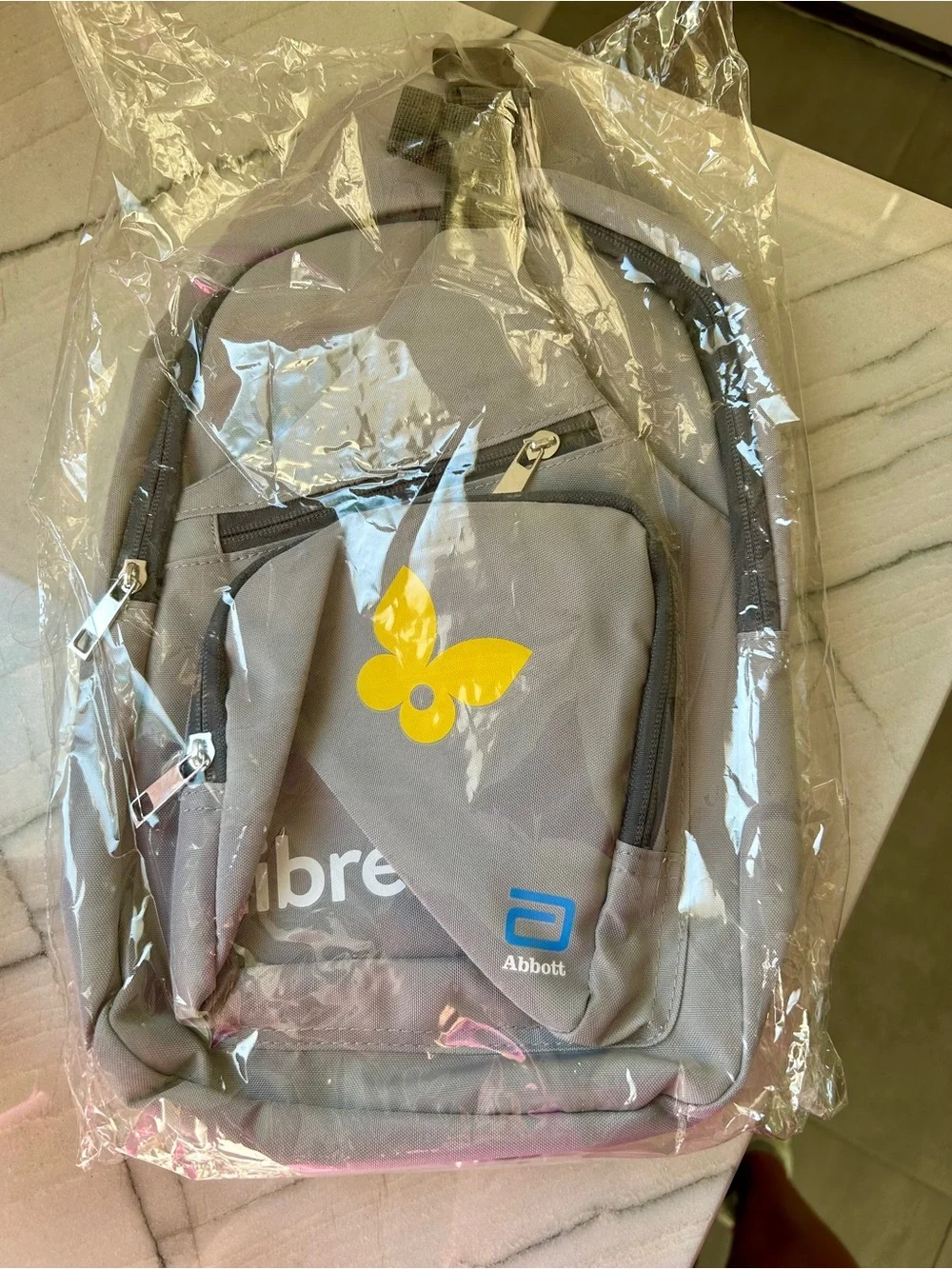 Sling backpack- gray, sponsored by Libre from Abbott.